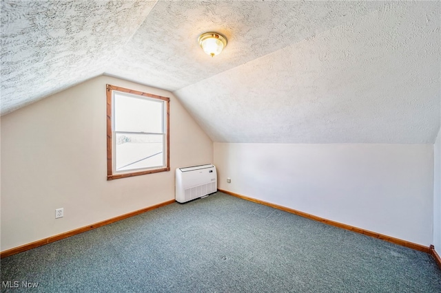 2457 Sheffield Rd, Jefferson, OH 44047 - bonus room with a textured ceiling, baseboards, lofted ceiling, carpet flooring, and heating unit