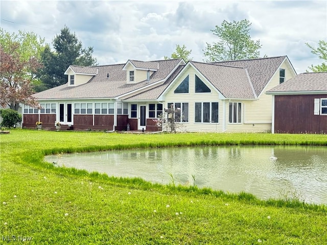 2457 Sheffield Rd, Jefferson, OH 44047 - back of property with a yard, a water view, and a shingled roof