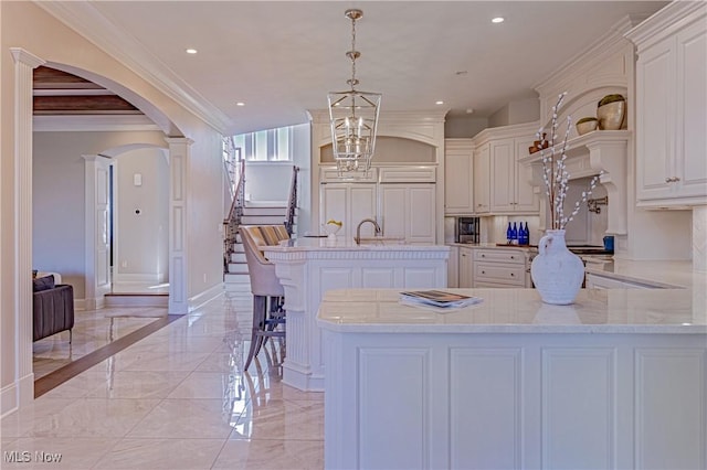 3377 E Galloway Dr, Richfield, OH 44286 - kitchen featuring arched walkways, a peninsula, ornamental molding, marble finish floor, and baseboards