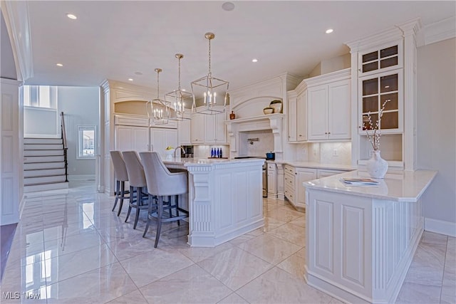 3377 E Galloway Dr, Richfield, OH 44286 - kitchen with tasteful backsplash, a kitchen breakfast bar, light countertops, white cabinetry, and marble finish floor