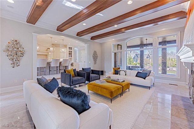 3377 E Galloway Dr, Richfield, OH 44286 - living room with decorative columns, arched walkways, baseboards, and beam ceiling