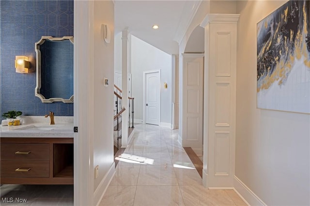 3377 E Galloway Dr, Richfield, OH 44286 - corridor featuring arched walkways, recessed lighting, stairway, a sink, and baseboards