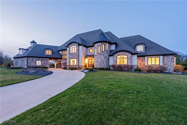 3377 E Galloway Dr, Richfield, OH 44286 - french country style house with a front yard, curved driveway, and stone siding