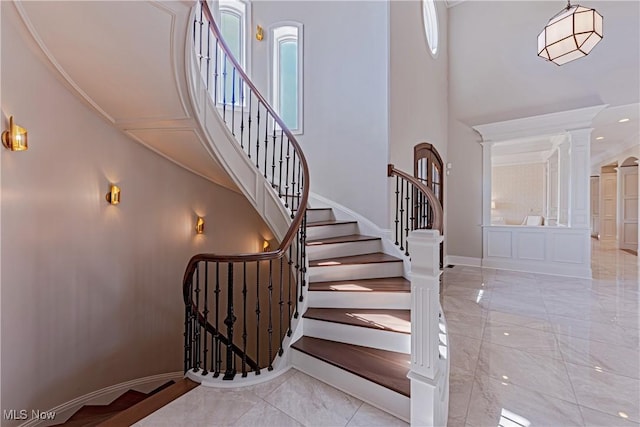 3377 E Galloway Dr, Richfield, OH 44286 - stairs with plenty of natural light, a high ceiling, baseboards, and marble finish floor
