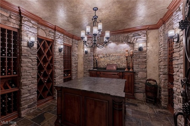 3377 E Galloway Dr, Richfield, OH 44286 - wine room with stone tile floors, an inviting chandelier, and ornamental molding