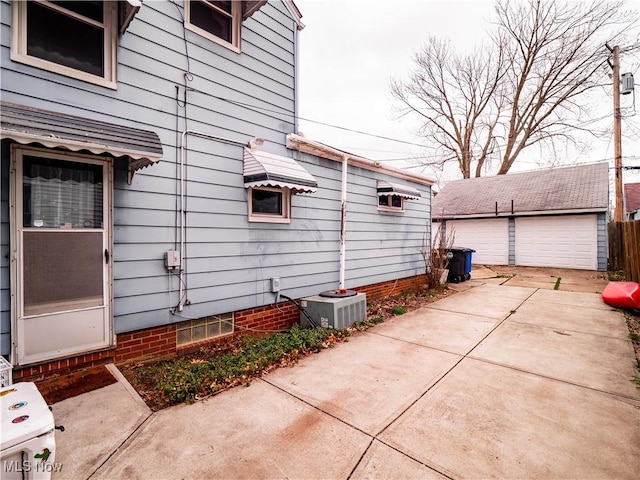 13908 Highlandview Ave, Cleveland, OH 44135 - view of side of home featuring a garage, an outbuilding, and central AC unit