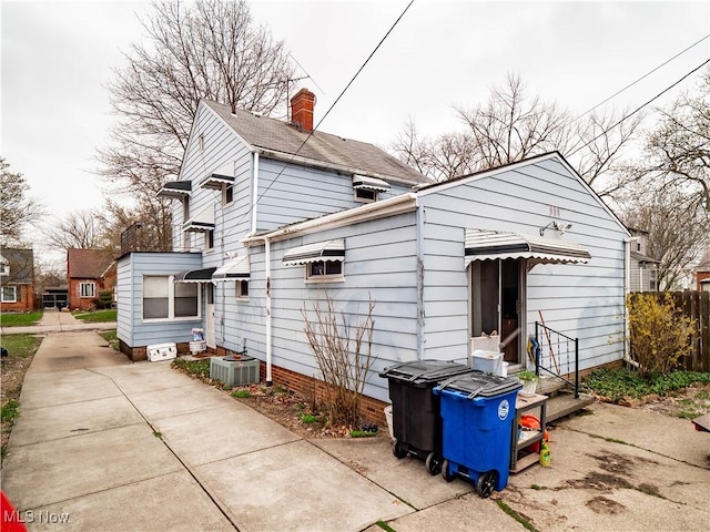 13908 Highlandview Ave, Cleveland, OH 44135 - exterior space featuring a chimney and cooling unit