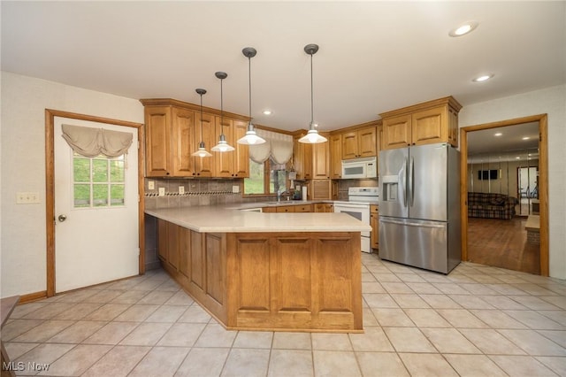 100 Crestwood Cir, Marietta, OH 45750 - kitchen featuring white appliances, a peninsula, light countertops, decorative backsplash, and light tile patterned floors