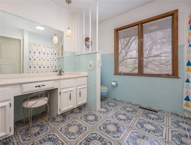 100 Crestwood Cir, Marietta, OH 45750 - bathroom with tile walls, tile patterned flooring, toilet, vanity, and wainscoting