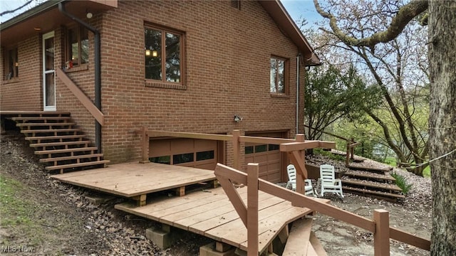 100 Crestwood Cir, Marietta, OH 45750 - rear view of house with brick siding, an attached garage, and stairs