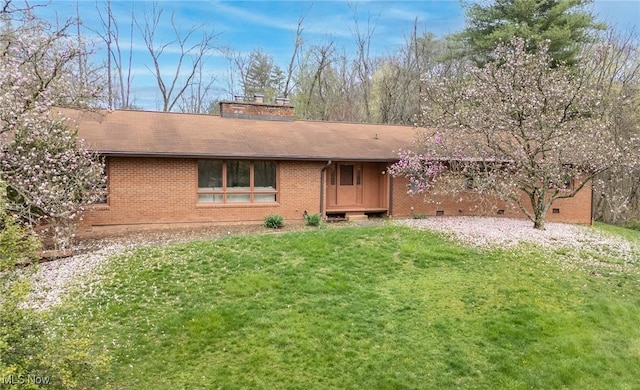 100 Crestwood Cir, Marietta, OH 45750 - view of front facade with brick siding, a front yard, a shingled roof, and a chimney