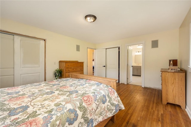 100 Crestwood Cir, Marietta, OH 45750 - bedroom featuring wood finished floors and two closets