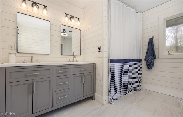 100 Crestwood Cir, Marietta, OH 45750 - full bath with wooden walls, double vanity, marble finish flooring, and a shower with curtain