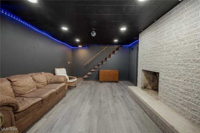 100 Crestwood Cir, Marietta, OH 45750 - living area with wood finished floors, stairway, and a brick fireplace