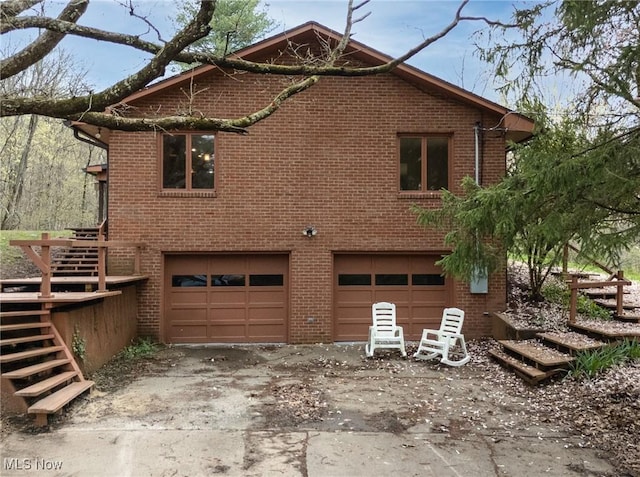 100 Crestwood Cir, Marietta, OH 45750 - view of property exterior with a garage, stairway, and brick siding