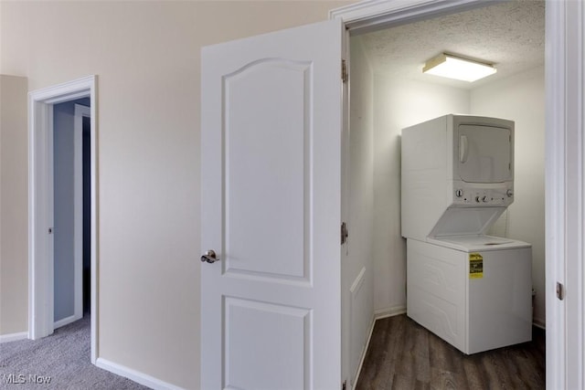 362 Village Pointe Dr, Akron, OH 44313 - washroom with dark wood-type flooring, laundry area, stacked washer and dryer, and baseboards
