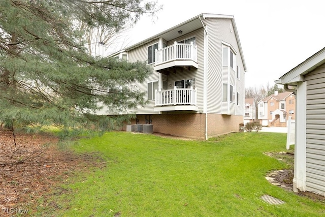 362 Village Pointe Dr, Akron, OH 44313 - rear view of house with a balcony, central AC, and a lawn