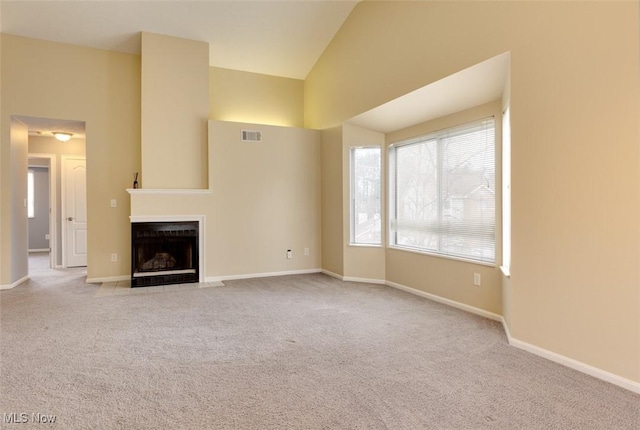 362 Village Pointe Dr, Akron, OH 44313 - unfurnished living room featuring baseboards, carpet floors, a fireplace with flush hearth, visible vents, and lofted ceiling