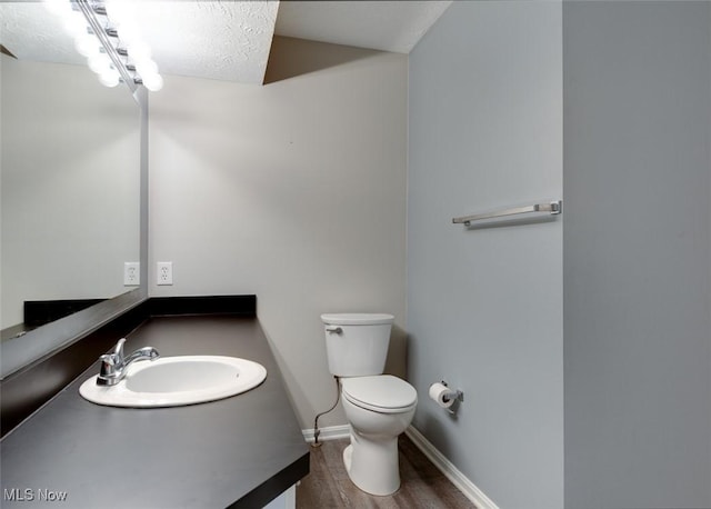 362 Village Pointe Dr, Akron, OH 44313 - half bath with vanity, baseboards, toilet, and wood finished floors