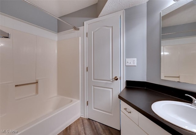 362 Village Pointe Dr, Akron, OH 44313 - bathroom with washtub / shower combination, vanity, and wood finished floors