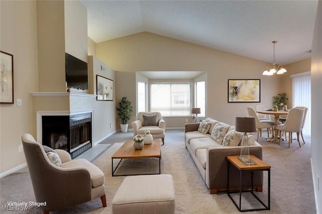 362 Village Pointe Dr, Akron, OH 44313 - living room featuring a notable chandelier, baseboards, vaulted ceiling, carpet floors, and a fireplace with flush hearth