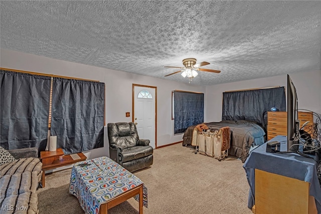 bedroom with ceiling fan, carpet, baseboards, and a textured ceiling
