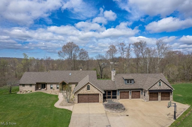 view of front facade with an attached garage, driveway, stone siding, and a front lawn