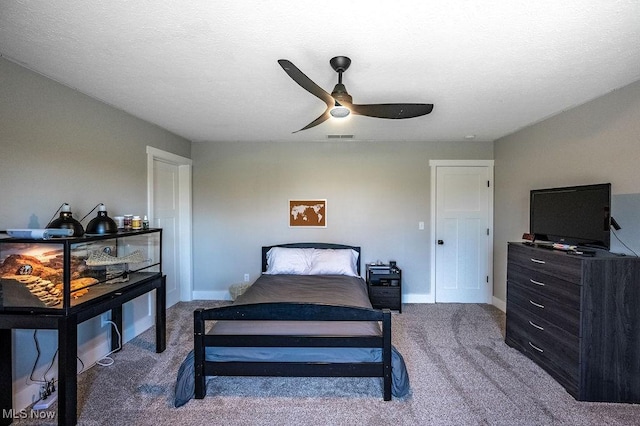 bedroom featuring a textured ceiling, a ceiling fan, visible vents, carpet floors, and baseboards