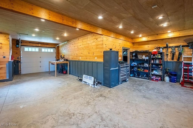 garage featuring wooden walls and recessed lighting