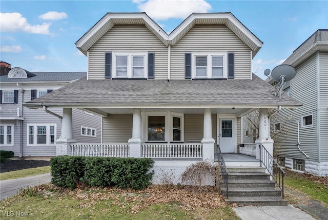view of front of property featuring a shingled roof and covered porch
