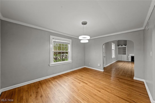 2484 Eaton Rd, University Heights, OH 44118 - unfurnished room featuring arched walkways, ornamental molding, light wood finished floors, and baseboards