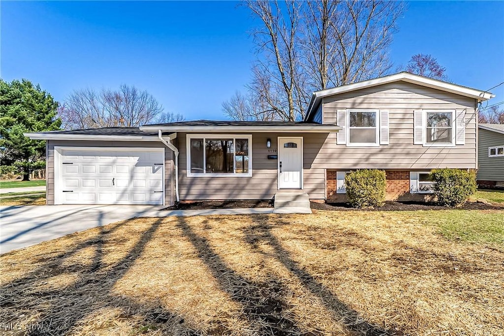 1139 Dover Center Rd, Westlake, OH 44145 - tri-level home featuring a garage and concrete driveway