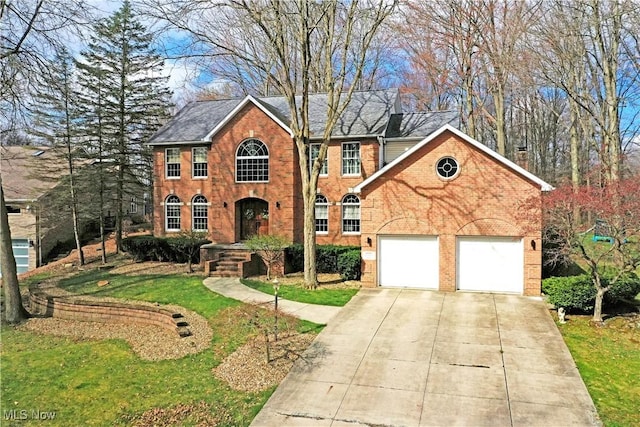 2248 Crestmont Dr, Girard, OH 44420 - view of front of house with brick siding, a front lawn, and concrete driveway