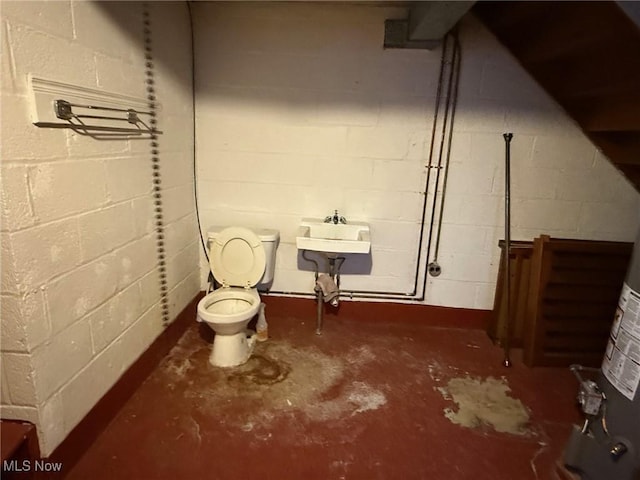 20614 Kings Hwy, Warrensville Heights, OH 44122 - bathroom with unfinished concrete flooring, a sink, toilet, and concrete block wall