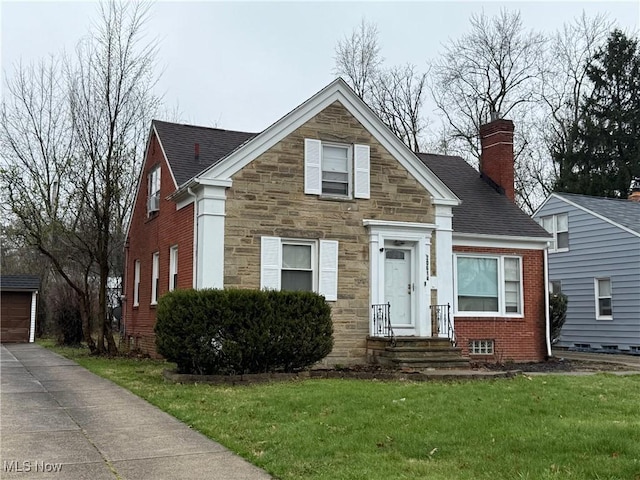 20614 Kings Hwy, Warrensville Heights, OH 44122 - view of front of property with an outbuilding, stone siding, a chimney, and a front lawn