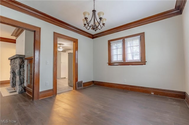empty room featuring ornamental molding, baseboards, and wood finished floors