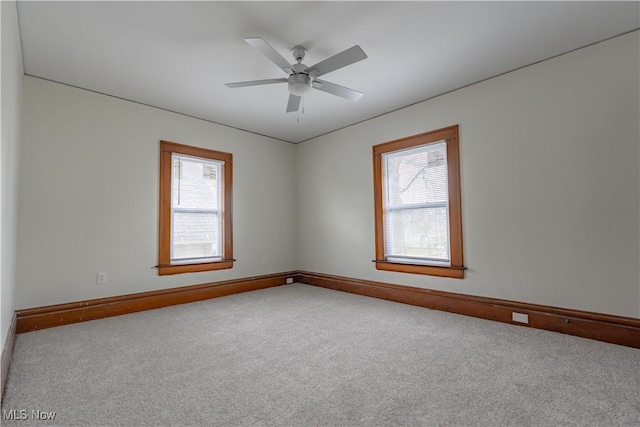 unfurnished room with carpet floors, baseboards, and plenty of natural light