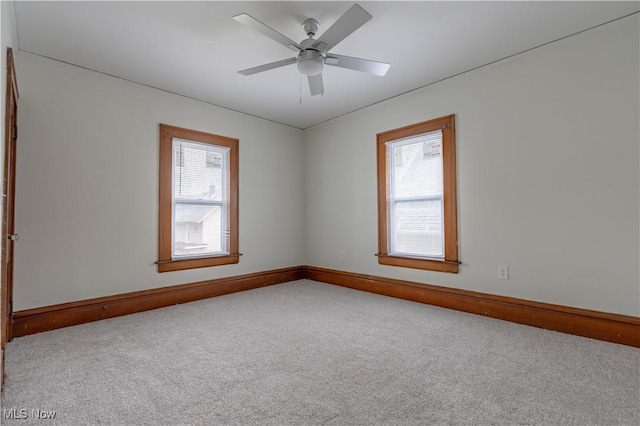 unfurnished room with baseboards, plenty of natural light, and carpet floors