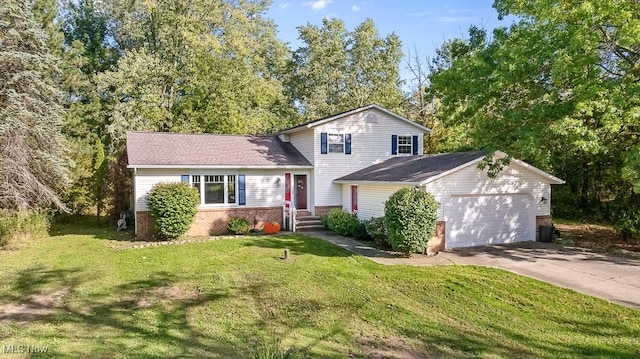7319 Guilford Rd, Seville, OH 44273 - split level home featuring concrete driveway, a front yard, brick siding, and an attached garage