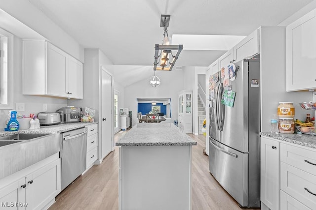 7319 Guilford Rd, Seville, OH 44273 - kitchen with a chandelier, white cabinetry, a kitchen island, light wood-style floors, and stainless steel appliances