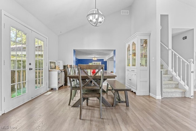 7319 Guilford Rd, Seville, OH 44273 - dining room with visible vents, high vaulted ceiling, light wood finished floors, and a chandelier