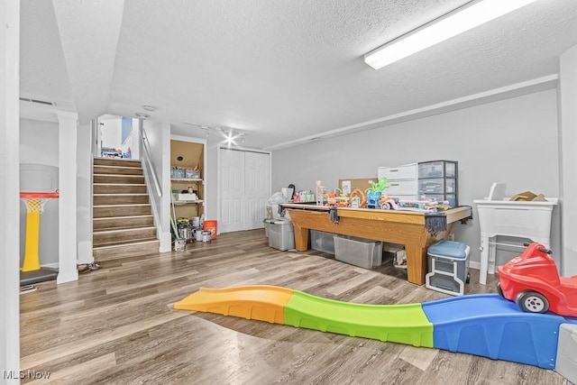 7319 Guilford Rd, Seville, OH 44273 - playroom featuring baseboards, wood finished floors, and a textured ceiling