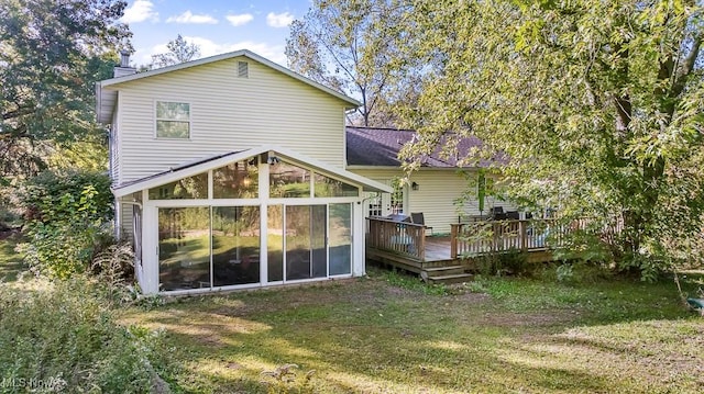7319 Guilford Rd, Seville, OH 44273 - back of property featuring a chimney, a wooden deck, a yard, a sunroom, and a shingled roof