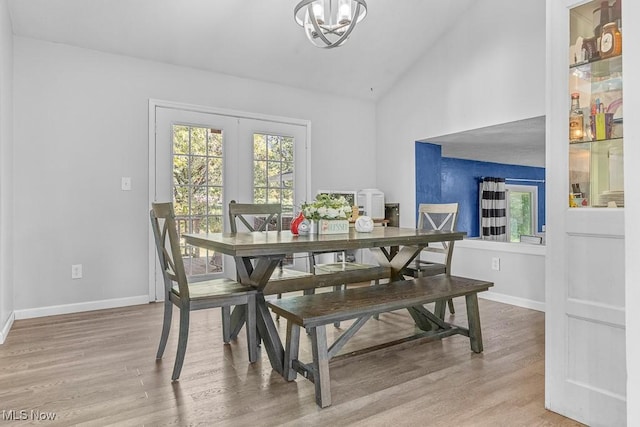 7319 Guilford Rd, Seville, OH 44273 - dining area with high vaulted ceiling, baseboards, an inviting chandelier, and wood finished floors