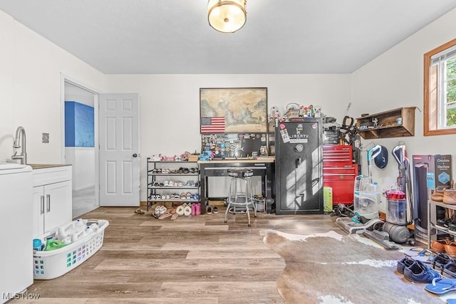 7319 Guilford Rd, Seville, OH 44273 - game room with washer / clothes dryer, a sink, and wood finished floors