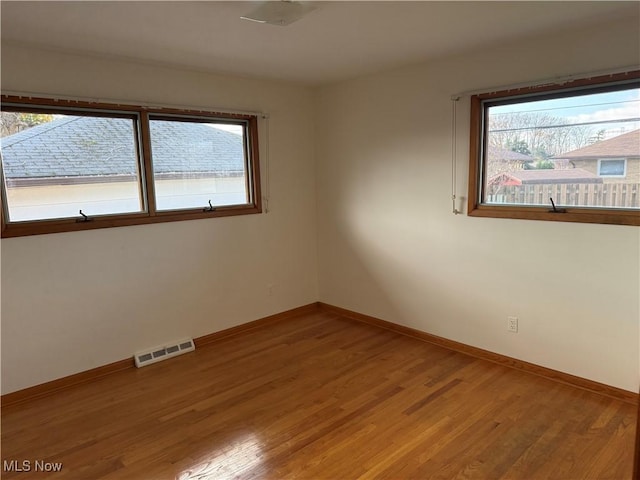 4830 Autumn Ln, Brooklyn, OH 44144 - empty room with light wood-style flooring, baseboards, visible vents, and plenty of natural light