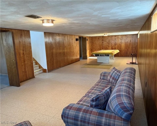 4830 Autumn Ln, Brooklyn, OH 44144 - living room with wooden walls, visible vents, tile patterned floors, and stairs
