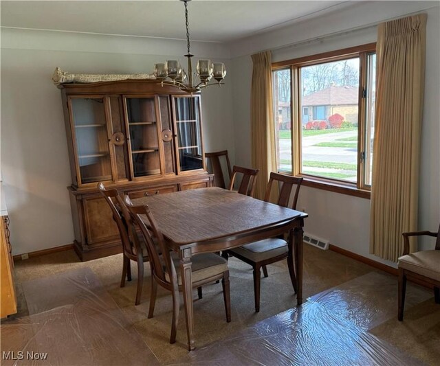 4830 Autumn Ln, Brooklyn, OH 44144 - carpeted dining area with visible vents, baseboards, and a chandelier