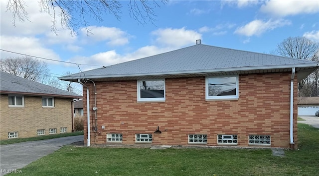 4830 Autumn Ln, Brooklyn, OH 44144 - view of side of home with a yard, a shingled roof, and brick siding