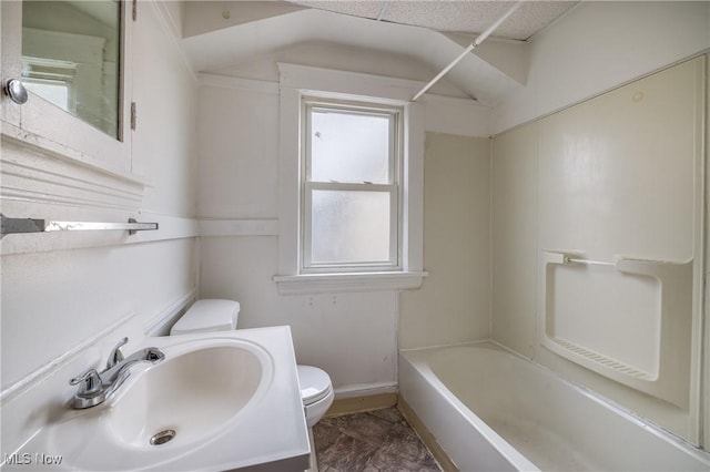 full bathroom with toilet, vanity, baseboards, and washtub / shower combination
